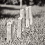 http://www.dreamstime.com/stock-photos-row-unmarked-small-child-headstones-vertical-black-white-image34299323